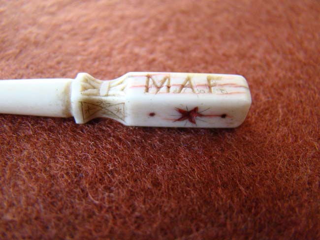 A charming 19th century sailor carved whalebone bodkin with red ink decoration and initials 'M A F' — image 2